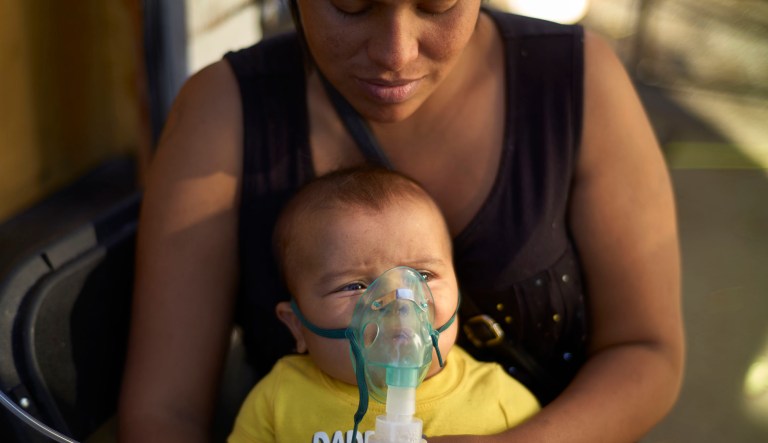 Honduran migrant Janet Zuniga holds her five-month-old son Linder, as he receives medical treatment outside a shelter, Monday, Nov. 26, 2018, in Tijuana, Mexico.