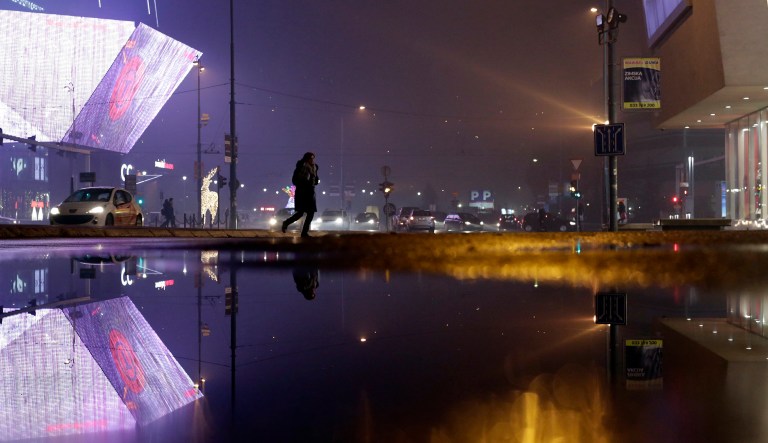 A woman woman walks on a street during high level of air pollution in Sarajevo, Bosnia, on Monday, Dec. 3, 2018. The COP24 UN Climate Change Conference is taking place in Katowice, Poland. Negotiators from around the world are meeting for talks on curbing climate change.