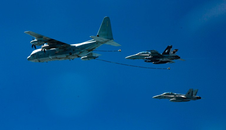 In this Oct. 13, 2016, photo provided by U.S. Marine Corps, two F/A-18D Hornets with Marine All-Weather Fighter Attack Squadron 533 approach a KC-130J with Marine Aerial Refueler Transport Squadron 352 during a Special Purpose Marine Air-Ground Task Force - Crisis Response - Central Command aerial refueling exercise in undisclosed location.  On Thursday, Dec. 6, 2018, two American warplanes crashed into the Pacific Ocean off Japan's southwestern coast after a midair collision,  and rescuers found one of the seven crew members in stable condition while searching for the others, officials said.  The U.S. Marine Corps said that the crash involved an F/A-18 fighter jet and a KC-130 refueling aircraft during regular training after the planes took off from their base in Iwakuni, near Hiroshima in western Japan.