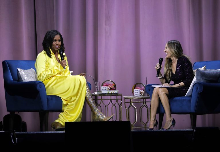 Former first lady Michelle Obama, left, is interviewed by Sarah Jessica Parker during an appearance for her book, "Becoming: An Intimate Conversation with Michelle Obama" at Barclays Center on Wednesday, Dec. 19, 2018, in New York.