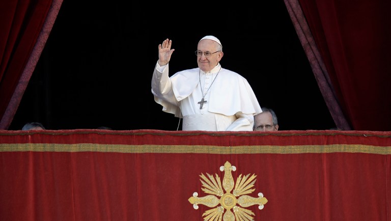 Pope Francis arrives to deliver the Urbi et Orbi (Latin for 'to the city and to the world' ) Christmas' day blessing from the main balcony of St. Peter's Basilica at the Vatican.
