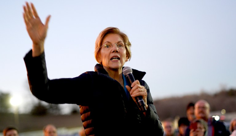 Sen. Elizabeth Warren, D-Mass, addresses an overflow crowd outside an organizing event at McCoy's Bar Patio and Grill in Council Bluffs, Iowa.