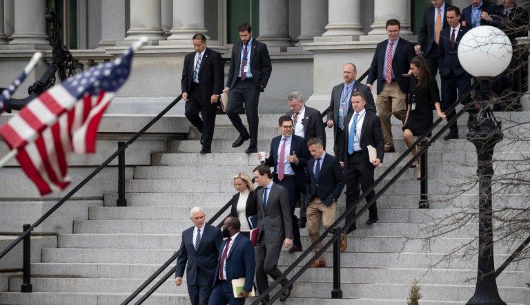 Vice President Mike Pence, left, White House legislative affairs aide Ja'Ron Smith, Homeland Security Secretary Kirstjen Nielsen, second row left, White House Senior Adviser Jared Kushner, and others, walk down the steps of the Eisenhower Executive Office building, on the White House complex, after a meeting with staff members of House and Senate leadership, Saturday, Jan. 5, 2019, in Washington.