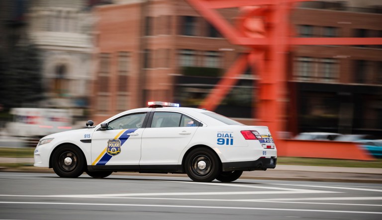 A police car drives with its lights flashing in Philadelphia.