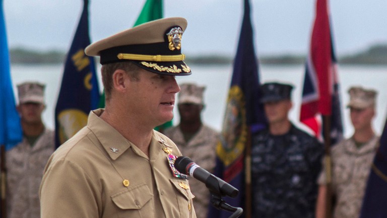 FILE - In this June 3, 2014, image provided by the U.S. Navy, Navy Capt. John R. Nettleton, then-commanding officer of Naval Station Guantanamo Bay, Cuba, speaks during a Battle of Midway commemoration ceremony.