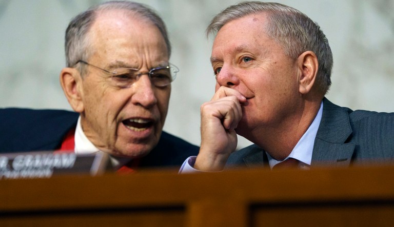 Senate Judiciary Committee Chairman Lindsey Graham, R-S.C., right, speaks with Sen. Chuck Grassley, R-Iowa, as Attorney General nominee William Barr testifies before the Senate Judiciary Committee on Capitol Hill in Washington, Tuesday, Jan. 15, 2019. 