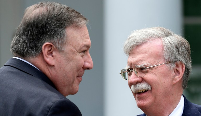 In this June 7, 2018, file photo, Secretary of State Mike Pompeo, left, and national security adviser John Bolton, right, talk before the start of a news conference.