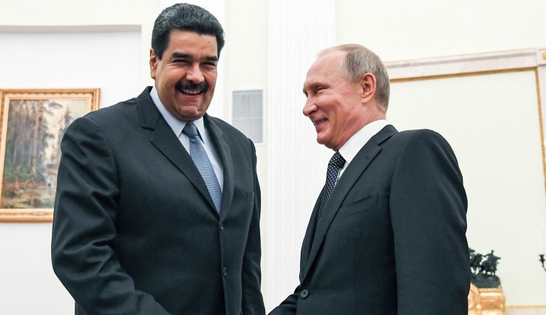 In this file pool photo taken on Oct. 4, 2017, Russian President Vladimir Putin, right, shakes hands with Venezuela's President Nicolas Maduro during their meeting at the Kremlin in Moscow, Russia.