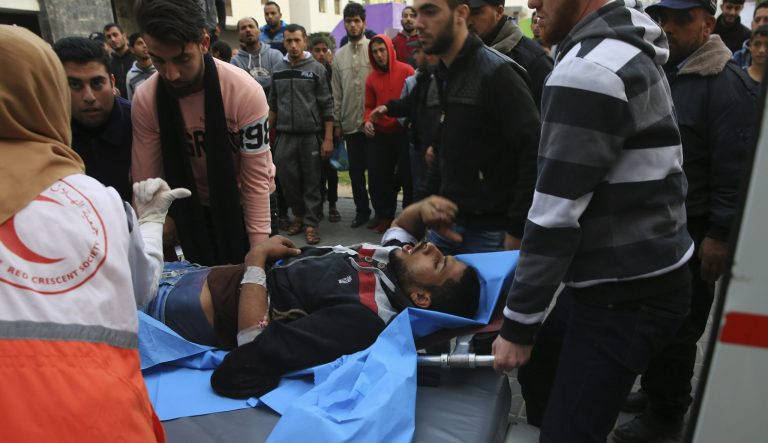Palestinian medics and protestors move a wounded youth, who was shot by Israeli troops during a protest at the Gaza Strip's border with Israel, into the treatment room of Shifa hospital in Gaza City, Friday, Feb. 1, 2019. 
