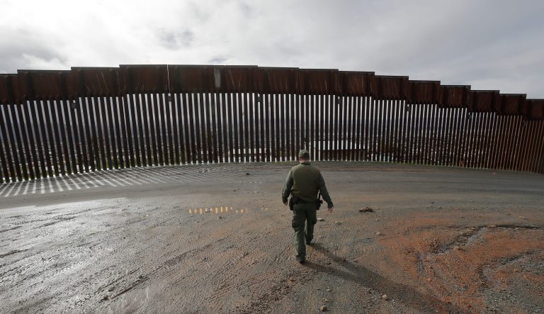 Border Patrol agent Vincent Pirro looks on near a border wall that separates the cities of Tijuana, Mexico, and San Diego, Tuesday, Feb. 5, 2019, in San Diego. 