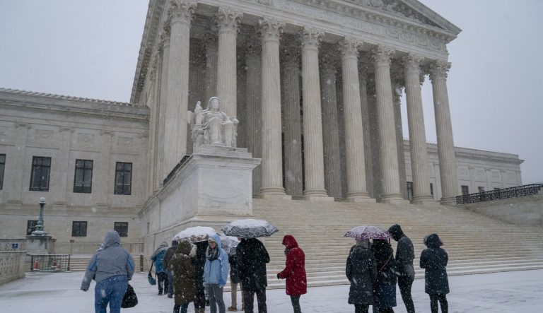 Visitors wait to enter the Supreme Court as a winter snow storm hits the nation's capital making roads perilous and closing most Federal offices and all major public school districts, on Capitol Hill in Washington, Wednesday, Feb. 20, 2019. 