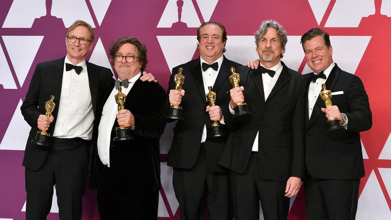 Jim Burke, from left, Charles B. Wessler, Nick Vallelonga, Peter Farrelly, and Brian Currie pose with the award for best picture for "Green Book" in the press room at the Oscars.