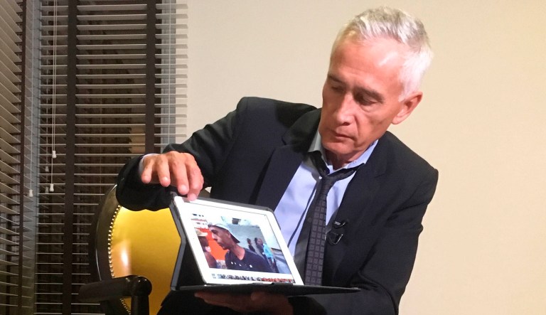 Univisionâs Jorge Ramos shows a video he says his crew shot the previous day showing Venezuelan youth picking food scraps out of the back of a garbage truck in Caracas, during an interview at a hotel in Caracas, Venezuela.