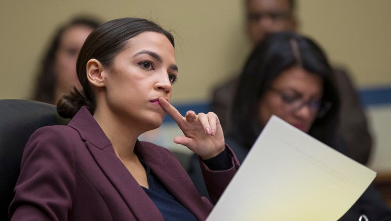 Rep. Alexandria Ocasio-Cortez, D-N.Y., listens to questions.