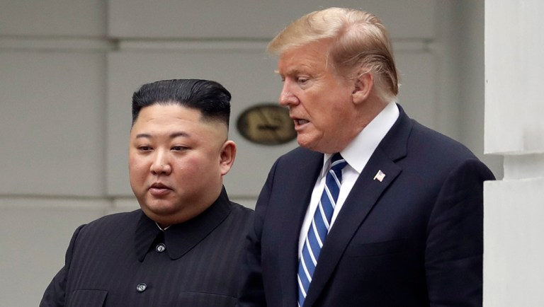 President Donald Trump and North Korean leader Kim Jong Un take a walk after their first meeting.