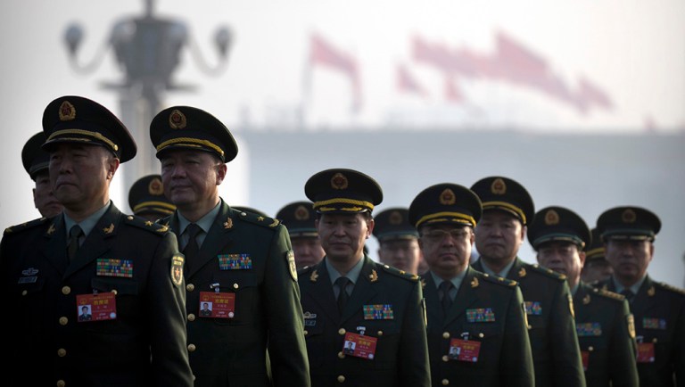 Military delegates arrive at the Great Hall of the People before the opening session of China's National People's Congress (NPC) in Beijing.