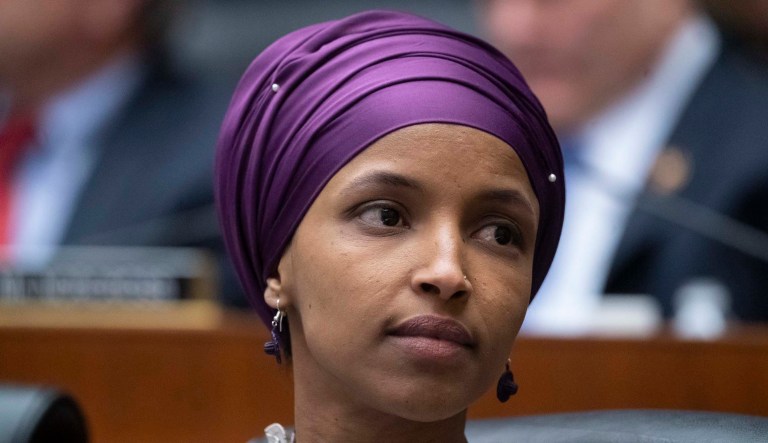 Rep. Ilhan Omar, D-Minn., sits with fellow Democrats.