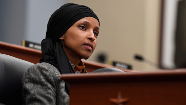 Rep. Ilhan Omar, D-Minn., listens.