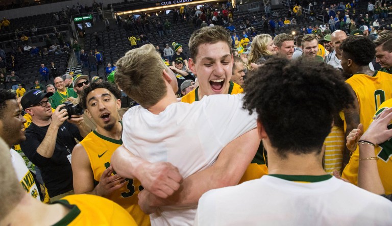 North Dakota State players celebrate after a win over Omaha during an NCAA college basketball game for the Summit League men's tournament championship, Tuesday, March 12, 2019, in Sioux Falls, S.D.