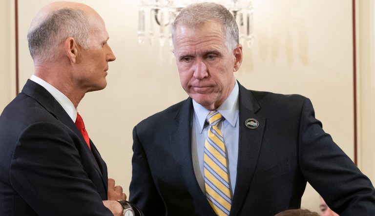 In this photo taken Wednesday, March 6, 2019, Sen.Thom Tillis, R-N.C., center, speaks with Sen. Rick Scott, R-Fla., before a Senate Armed Services subcommittee hearing, on Capitol Hill in Washington. Tillis has said he will vote to block President Donald Trump's border emergency as some GOP senators plan to join Democrats in a rebuke of Trump's declaration of a national emergency at the Mexican border.