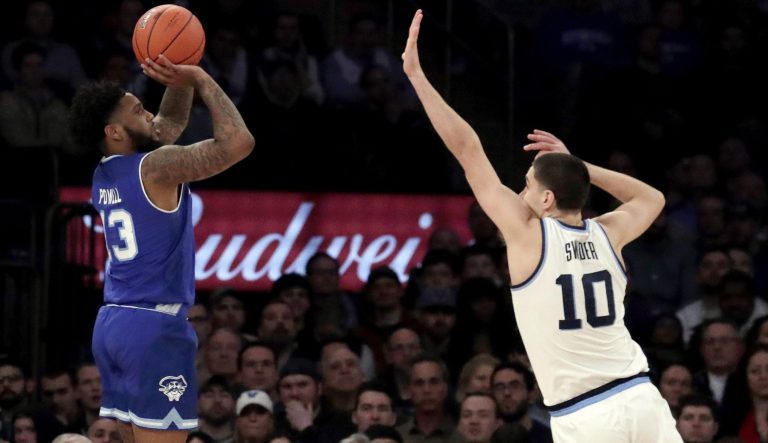 Seton Hall guard Myles Powell (13) shoots against Villanova forward Cole Swider (10) during the first half of an NCAA college basketball game in the championship of the Big East Conference tournament, Saturday, March 16, 2019, in New York. 
