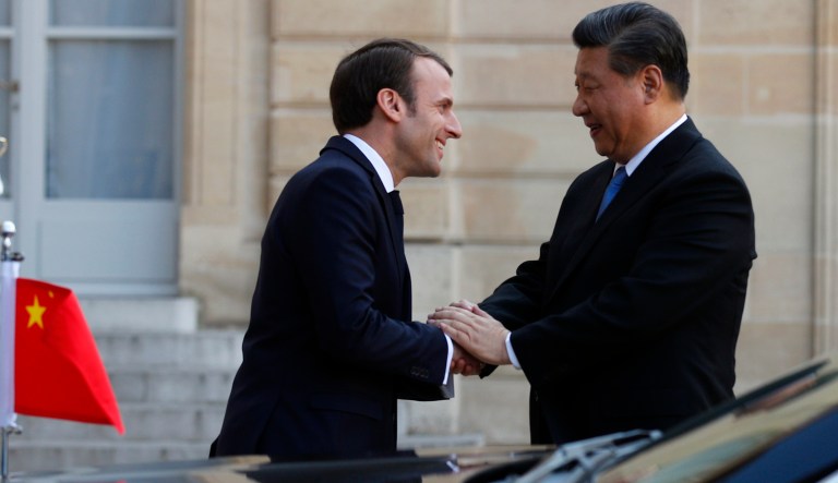 French President Emmanuel Macron, left, welcomes Chinese President Xi Jinping at the Elysee presidential palace in Paris, Tuesday, March 26, 2019. The leaders of China and France are trying to ramp up efforts against climate change and are calling for a global rethink of investments to make them more planet-friendly.