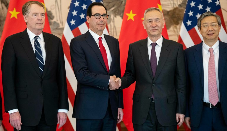 China's Vice Premier Liu He, second right, shakes hands with U.S. Treasury Secretary Steven Mnuchin, second left, as Yi Gang, right, governor of the People's Bank of China (PBC) and U.S. Trade Representative Robert Lighthizer pose for a group photo at Diaoyutai State Guesthouse in Beijing Friday, March 29, 2019.