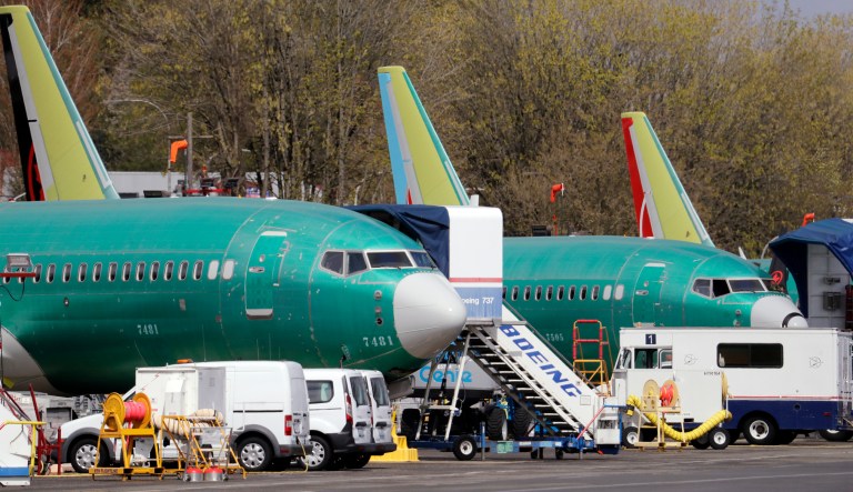 In this Monday, April 8, 2019 photo, Boeing 737 MAX 8 jets, built for American Airlines, left, and Air Canada are parked at the airport adjacent to a Boeing Co. production facility in Renton, Wash. Orders and deliveries of Boeing's 737 Max plunged in the first quarter as the plane was grounded around the world following a second deadly crash. Boeing disclosed Tuesday, April 9, that it received no new orders for the Max in March. 