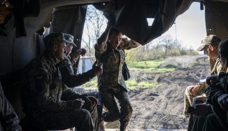 A Ukrainian serviceman scrambles into a military truck near the front line as the conflict continues in Donetsk region, eastern Ukraine, Sunday, April 21, 2019. Top issues in the election have been corruption, the economy and how to end the conflict with Russia-backed rebels in eastern Ukraine. 