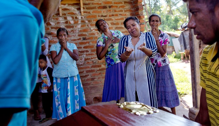 Relatives weep near the coffin with the remains of 12-year-old Sneha Savindi, who was a victim of Easter Sunday bombing at St. Sebastian Church, Monday, April 22, 2019 in Negombo, Sri Lanka.