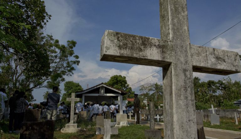 Family members gather at a funeral of Easter Sunday bomb blast victim at Methodist cemetery in Negombo, Sri Lanka, Tuesday, April 23, 2019. 
