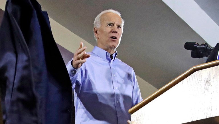 Former Vice President and Democratic presidential candidate Joe Biden tosses his jacket off.