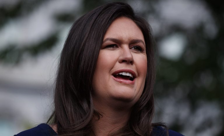 Sarah Sanders talks with reporters outside the White House, Wednesday, May 22, 2019, in Washington. 