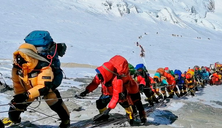 In this May 22, 2019 photo, a long queue of mountain climbers line a path on Mount Everest just below camp four in Nepal. 