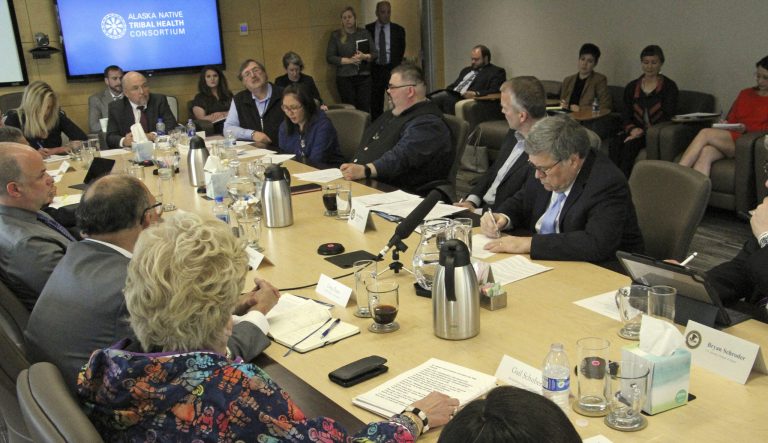 U.S. Attorney General William Barr, seated at right, takes notes as he listens to concerns raised about public safety in rural Alaska during at a roundtable discussion at the Alaska Native Tribal Health Consortium on Wednesday, May 29, 2019, in Anchorage, Alaska. 