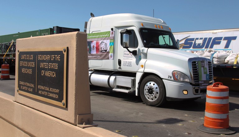 In this Oct. 21, 2011, file photo, a truck crosses the border between Mexico and the United States in Nuevo Laredo, Mexico. President Donald Trump says he has "indefinitely suspended" tariffs he has threatened to impose Monday on Mexican imports. Trump says on Twitter that the U.S. and Mexico "reached a signed agreement" Friday, June 7, 2019 night. The president says Mexico "has agreed to take strong measures to stem the tide of Migration through Mexico, and to our Southern Border." 