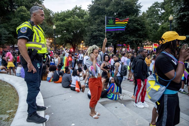 Police keep watch at Dupont Circle at the conclusion of the Capitol Pride Parade in Washington, Saturday, June 8, 2019. Officials in Washington say several people were injured after a panic at the LGBTQ pride parade sent people running through the streets of the nation's capital. 