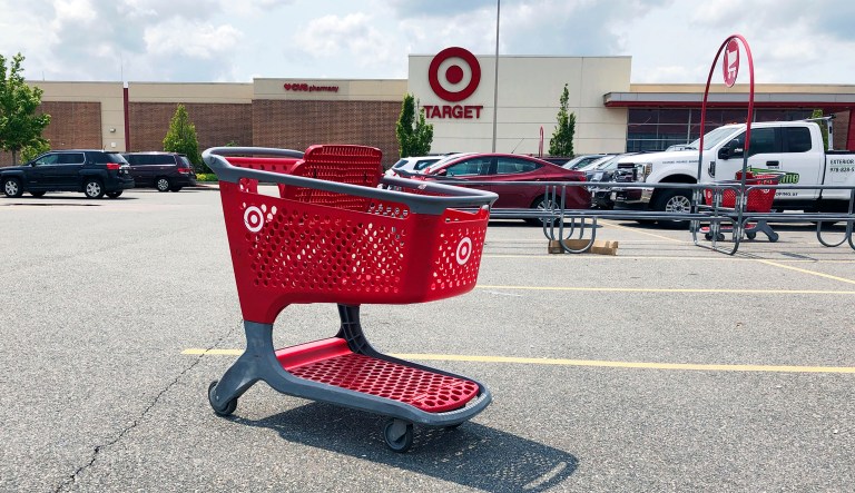 FILE - In this June 3, 2019, file photo a shopping cart sits in the parking lot of a Target store in Marlborough, Mass. On Friday, June 14, the Commerce Department releases U.S. retail sales data for May.