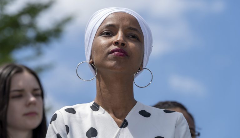 Rep. Ilhan Omar, D-Minn., listens as she joins Democratic presidential candidate, Sen. Bernie Sanders, I-Vt., to call for legislation to cancel all student debt, at the Capitol in Washington, Monday, June 24, 2019. 