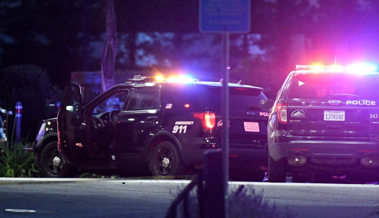 Law enforcement vehicles are parked outside a building at a Ford dealership after a fatal shooting Tuesday, June 25, 2019, in Morgan Hill, Calif. A man who had just been fired from the dealership shot and killed two employees and then killed himself, police and witnesses said.