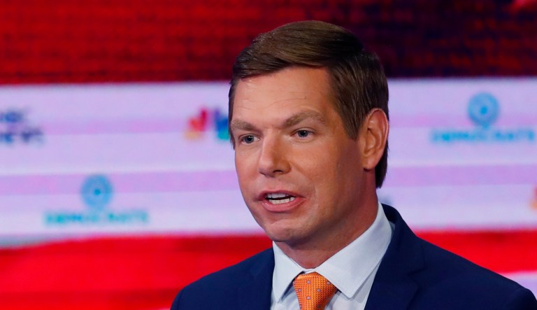 Democratic presidential candidate Rep. Eric Swalwell, D-Calif., right, speaks during the Democratic primary debate hosted by NBC News at the Adrienne Arsht Center for the Performing Arts in Miami.
