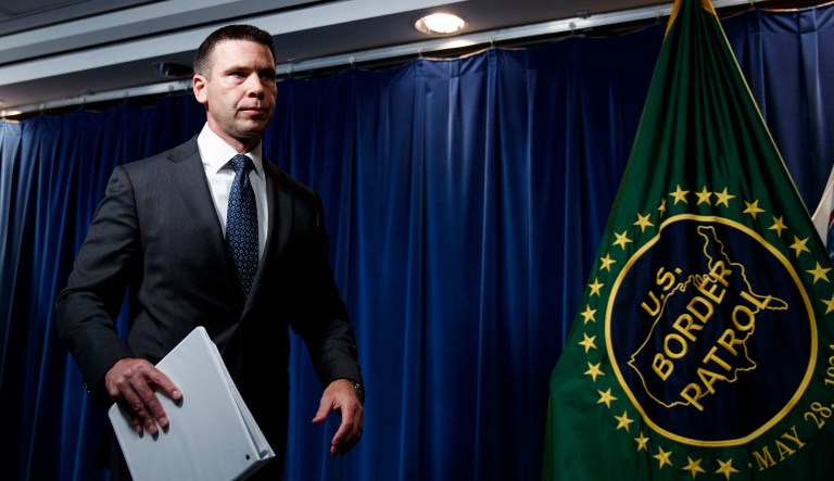Department of Homeland Security acting Secretary Kevin McAleenan leaves a news conference in Washington.