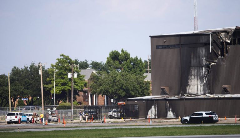 Damage is seen to a hangar after a twin-engine plane crashed into the building at Addison Airport in Addison, Texas, Sunday, June 30, 2019. 