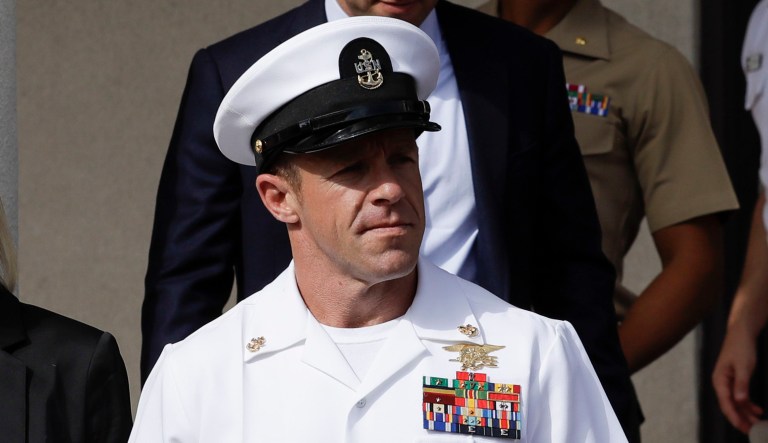 Navy Special Operations Chief Edward Gallagher, center, walks with his wife, Andrea Gallagher, as they leave a military court on Naval Base San Diego.
