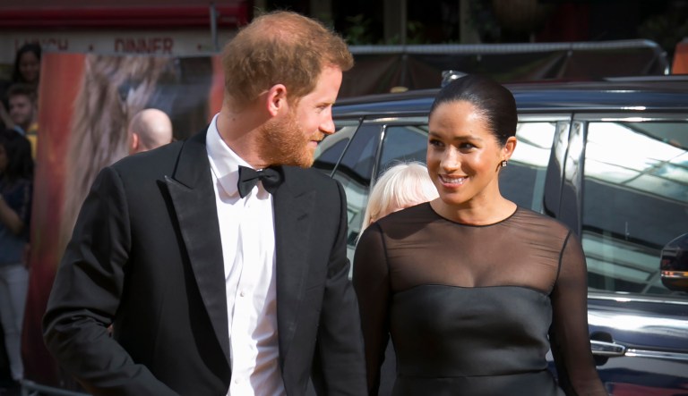 Britain's Prince Harry, left, and Meghan, Duchess of Sussex arrive at an event.