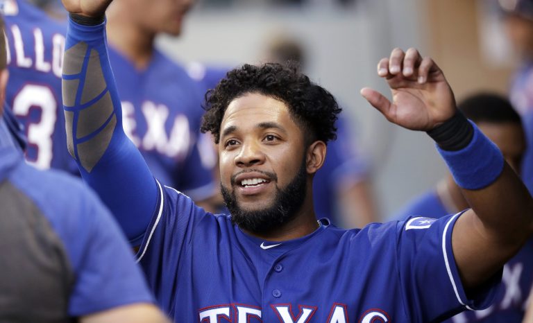 Texas Rangers' Elvis Andrus is congratulated after scoring against the Seattle Mariners in the first inning of a baseball game Monday, July 22, 2019, in Seattle. 