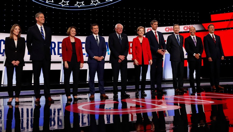 Democratic candidates for the 2020 presidential election are seen on a debate stage.