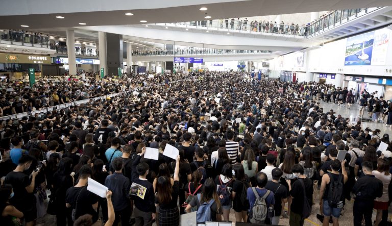 Protesters demonstrate at the airport in Hong Kong, Monday, Aug. 12, 2019. Several thousand people gathered on Monday for a fourth day of protest against a proposed extradition law at Hong Kong's busy international airport. 