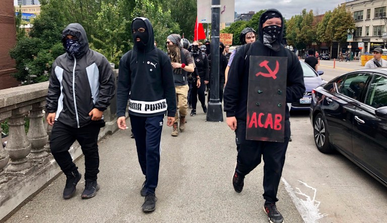 Anti-fascist counterdemonstrators cross the Burnside Bridge across the Willamette River from the west side of the city to the east side in search of the far-right group, the Proud Boys, in Portland, Oregon, on Saturday. Self-described anti-fascists vowed to confront the rally while leaders from the far right urged their followers to turn out in large numbers to protest the arrests of multiple members of right-wing groups in the run-up to the event. Antifa members often cover their faces with masks, making it harder to identify them. 