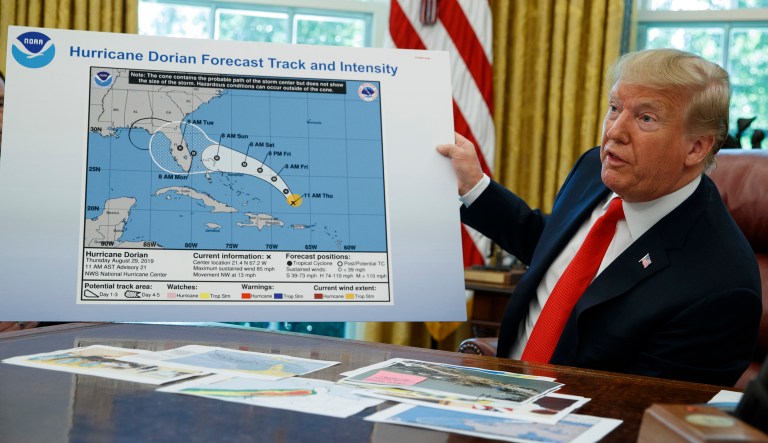 President Trump talks with reporters after receiving a briefing on Hurricane Dorian in the Oval Office of the White House Wednesday in Washington.